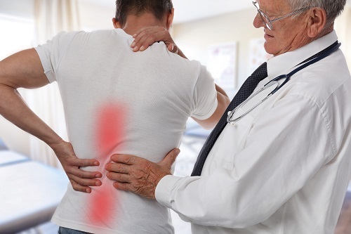 Doctor Treating Man with Back Pain
