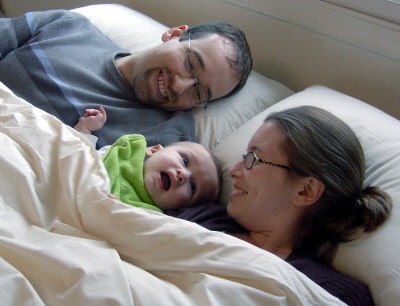 Parents in Wool Bedding with Baby