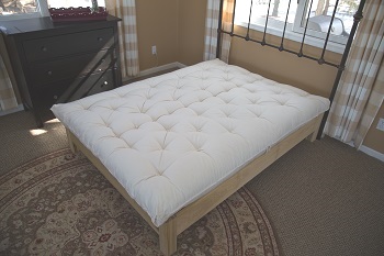 Wool mattress on wood bed frame